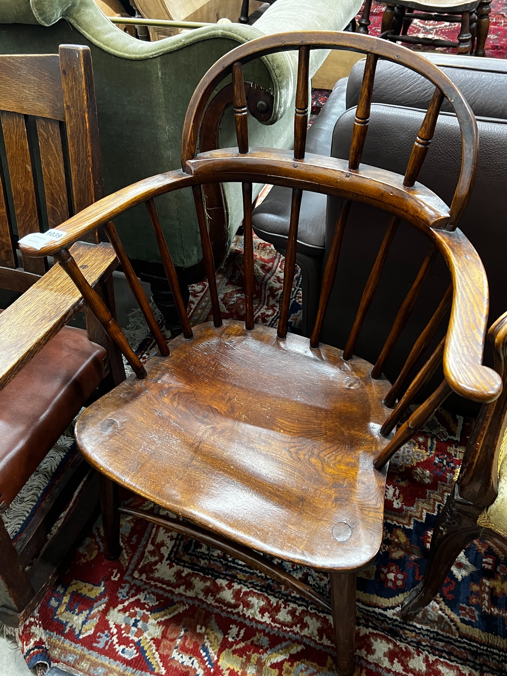 An early 20th century Windsor ash and elm comb back elbow chair, width 66cm, depth 41cm, height 92cm